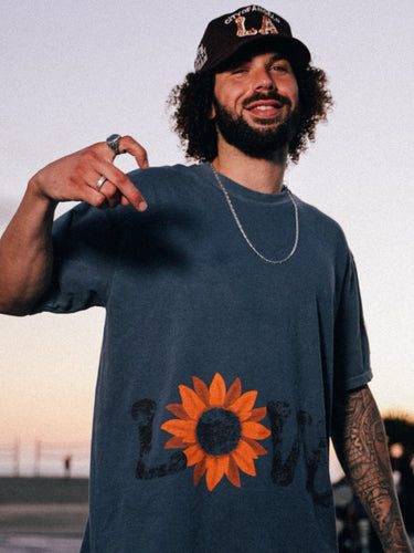 Chioke in Good Quality Human blue love tee and City of Angels hat